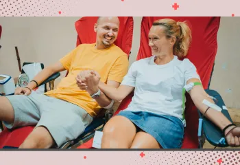 A man and a woman at the Blood Drive together holding hands