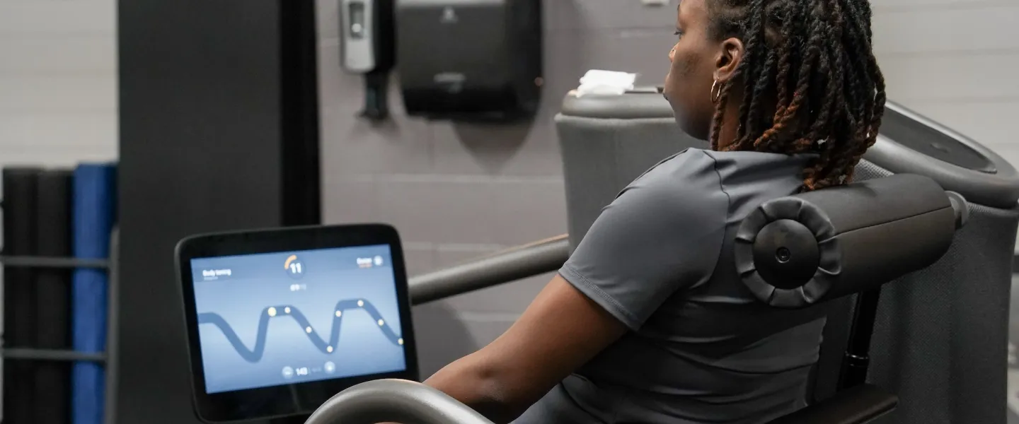 Woman at Strat-Richardson YMCA working out on en EGYM equipment machine