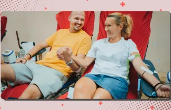 A man and a woman at the Blood Drive together holding hands