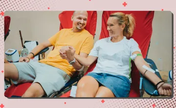 A man and a woman at the Blood Drive together holding hands
